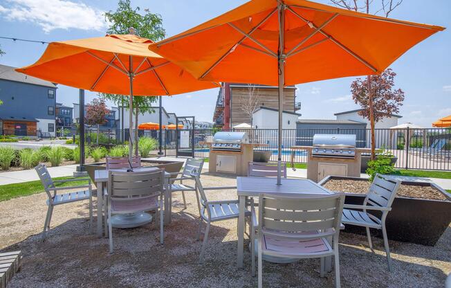 a group of lawn chairs under an umbrella
