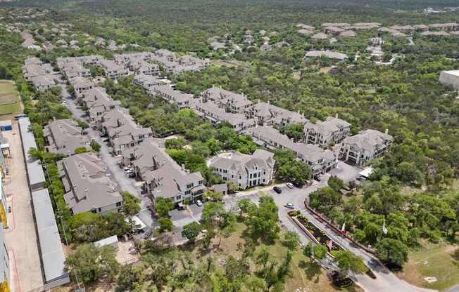 A bird's eye view of a residential area with houses and trees.