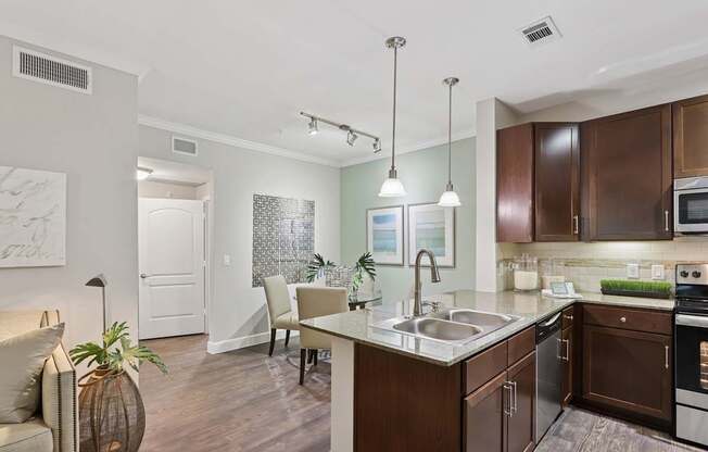 A kitchen with brown cabinets and a white counter.