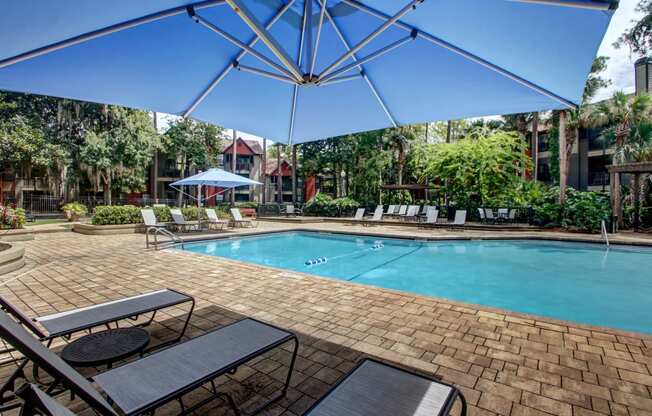 a swimming pool with tables and umbrellas