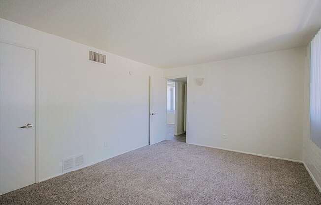 a bedroom with a carpeted floor and white walls