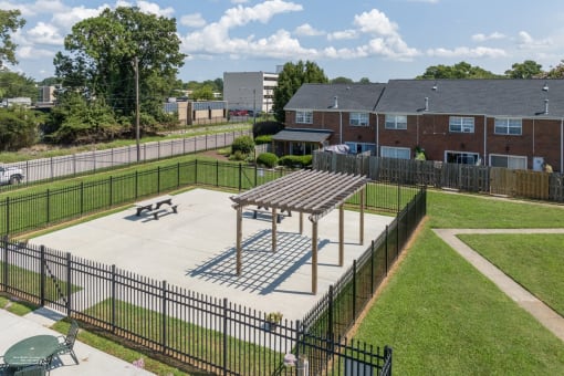 a picnic table in a park in front of a building