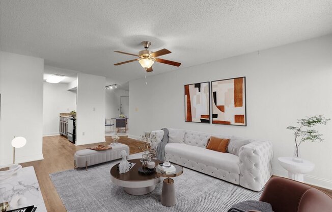 an open living room with furniture and a ceiling fan