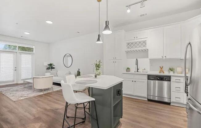 A modern kitchen with a dining table and chairs.