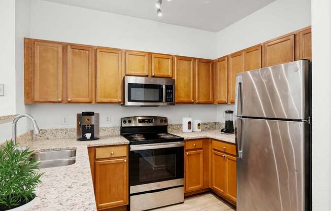 A kitchen with wooden cabinets and stainless steel appliances.