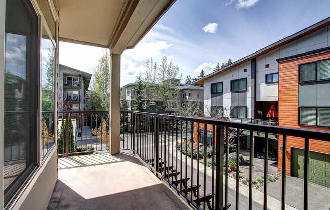 a balcony with a view of a courtyard and some buildings  at Delano, Washington, 98052