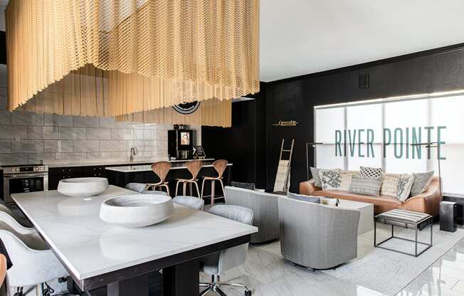 a kitchen and living room with black walls and white tiles