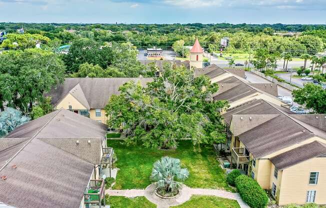 an aerial view of a neighborhood with houses and trees