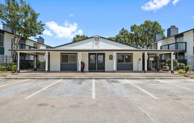 the entrance to a building with a parking lot