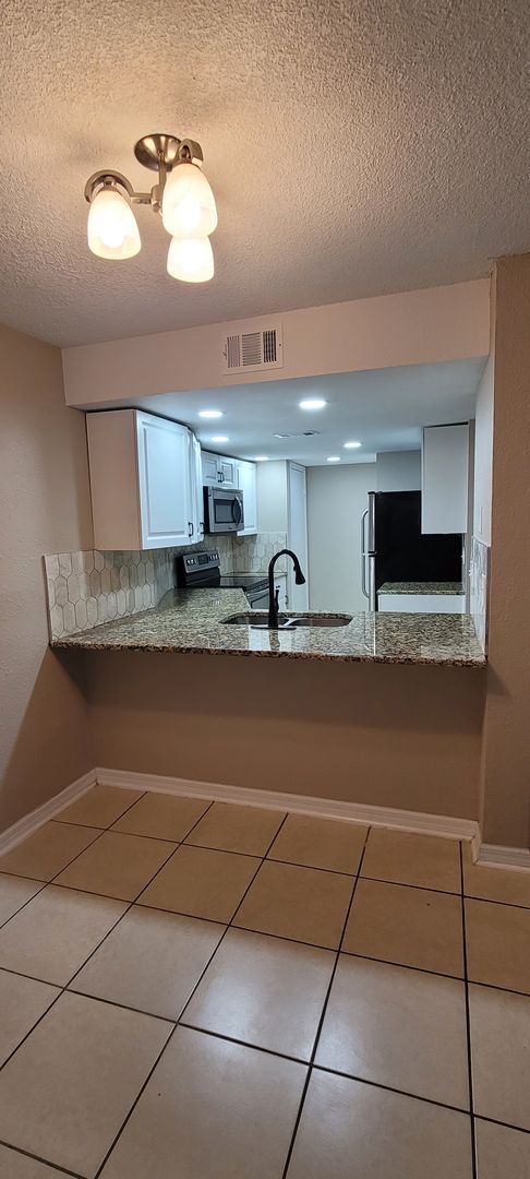 Modern One-Story Ground Floor Condo, Conveniently Located Near Tampa Palms and USF