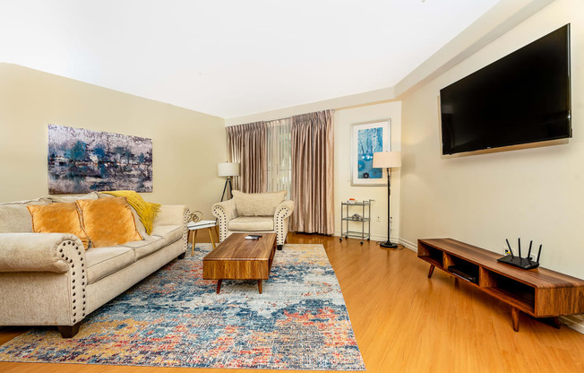 a living room with a couch and two chairs and a coffee table