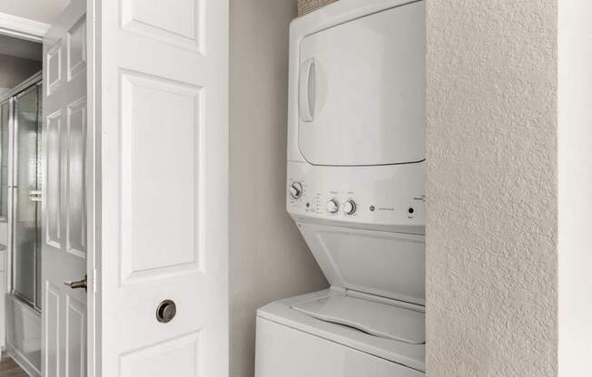 A white oven in a kitchen with a white door.