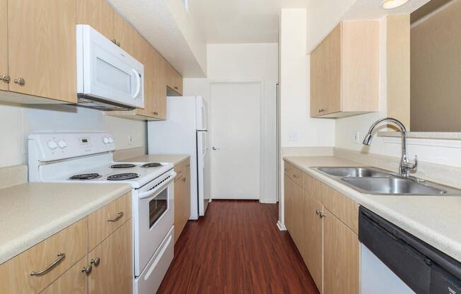 a kitchen with a stove a sink and a microwave