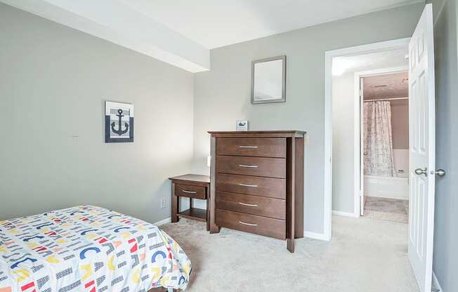 a bedroom with a bed and a dresser