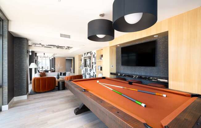 a pool table in a living room with a tv