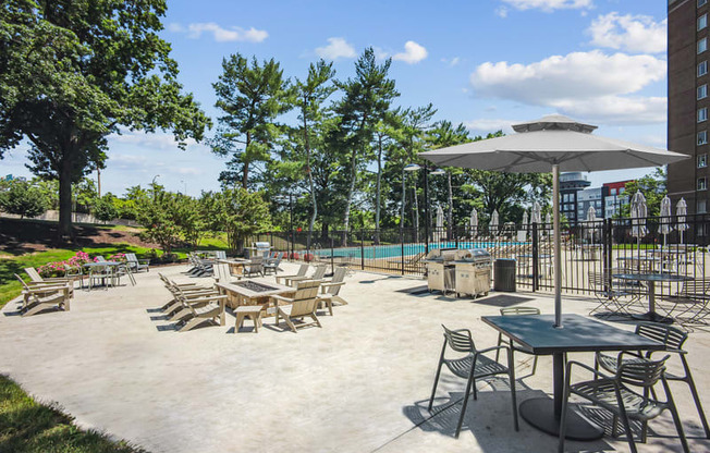 a patio with tables and chairs and a swimming pool