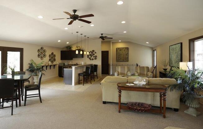 a living room filled with furniture and a ceiling fan