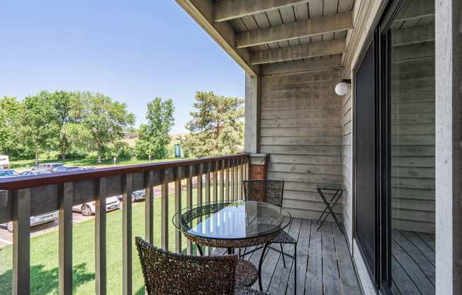 Private deck with chairs and a view of trees