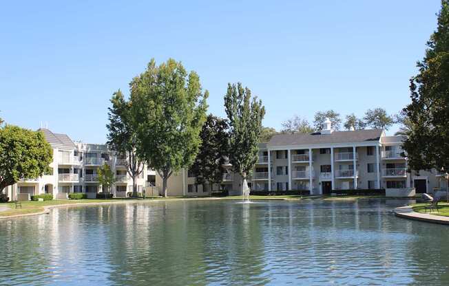 A large building with a pond in front of it.