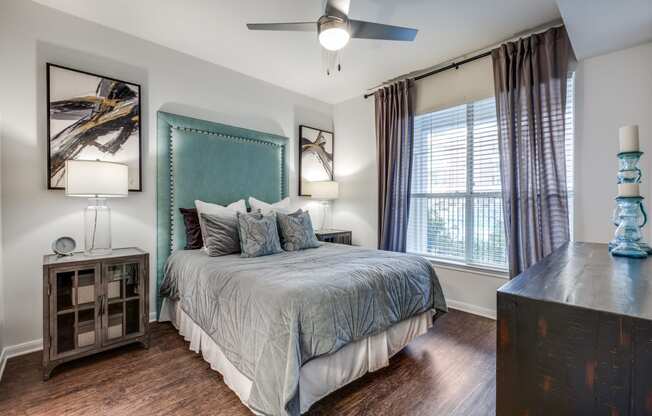 a bedroom with a large bed and a ceiling fan