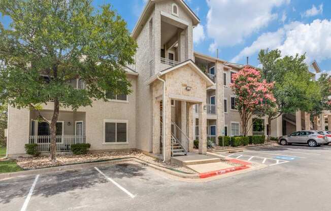 A building with a parking lot in front of it.
