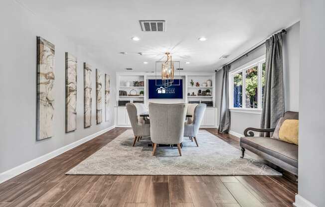 a dining room with a table and chairs and a window