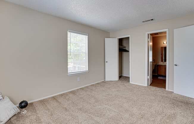 spacious bedroom with carpet & ceiling fan and closet  at Arbors Of Cleburne, Cleburne