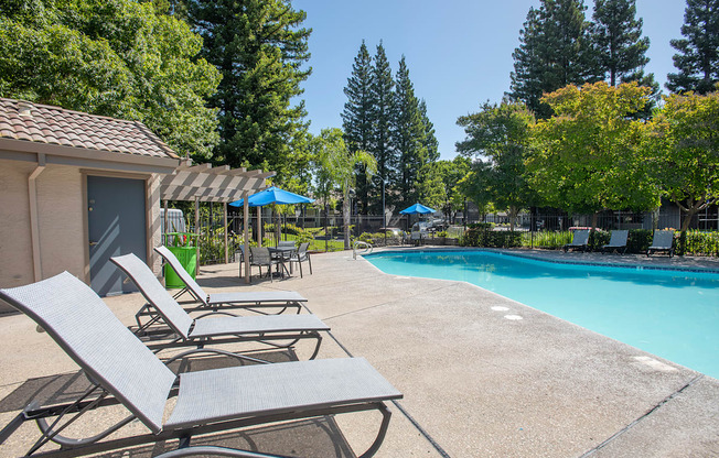 A pool area with sun loungers at Zinfandel Village Apartments, California, 95670