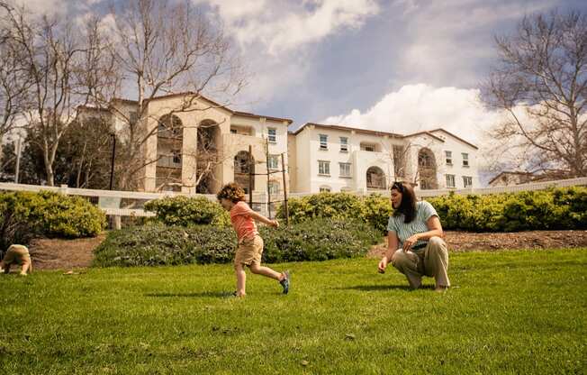 a woman playing with a child in a park at Arrive Temecula, California