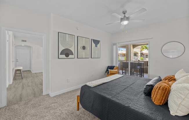 a bedroom with a bed and a ceiling fan