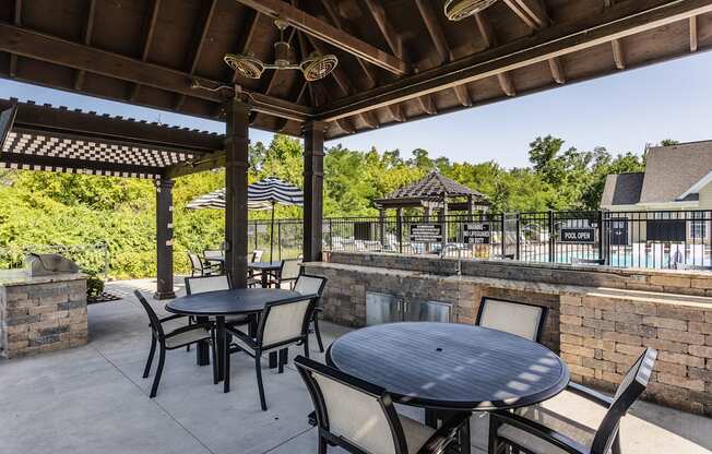 an outdoor patio with tables and chairs and a pool