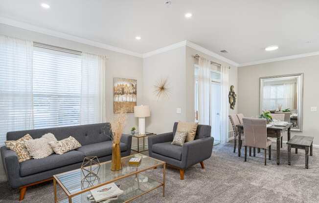 a living room with two couches and a glass table