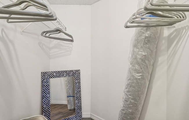 A mirror with a blue frame is on the floor.