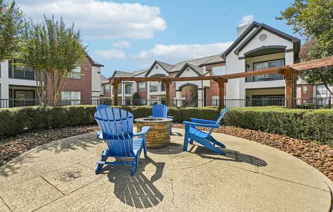 A blue chair sits on a patio in front of a building.