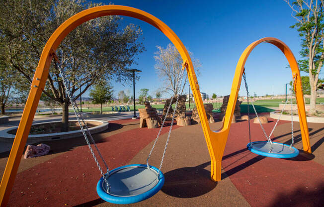a swing set on a playground at a park