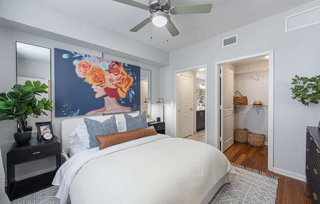 a bedroom with a large bed and a ceiling fan