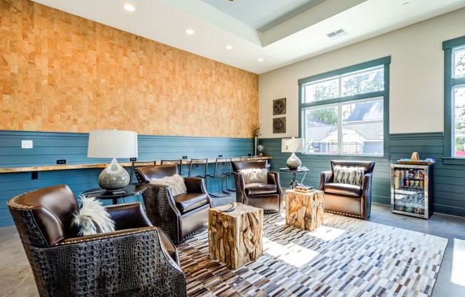 a living room with chairs and tables and a large window at Woodcreek, Poulsbo Washington