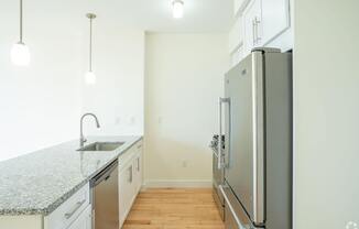 A kitchen with a granite countertop and stainless steel appliances. at 603 Concord Apartments, Massachusetts, 02138