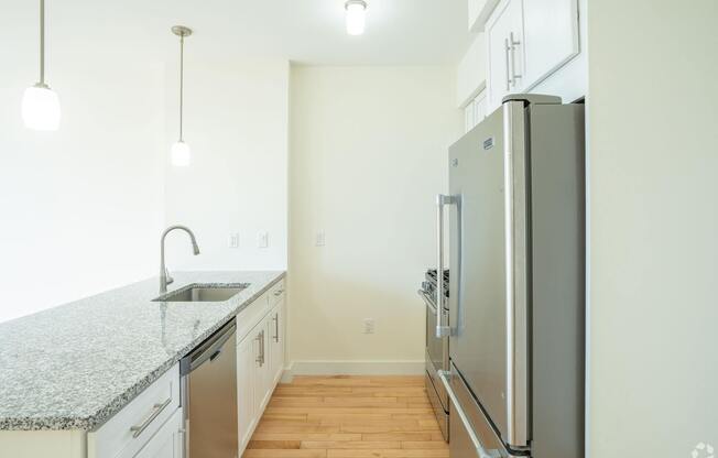 A kitchen with a granite countertop and stainless steel appliances. at 603 Concord Apartments, Massachusetts, 02138