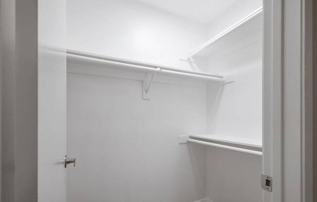 a walk in closet with a white wall and a white door at Huntington Terrace North Senior, Huntington Beach, 92648