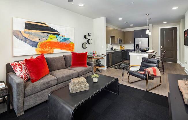 A modern living room with a view of the kitchen