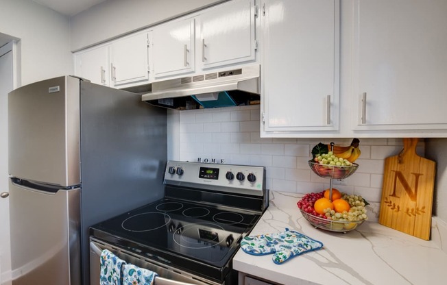 a kitchen with stainless steel appliances and white cabinets