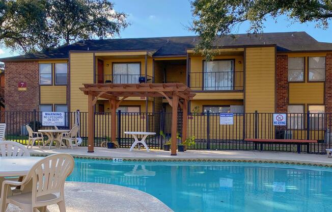 a house with a pool in front of a building