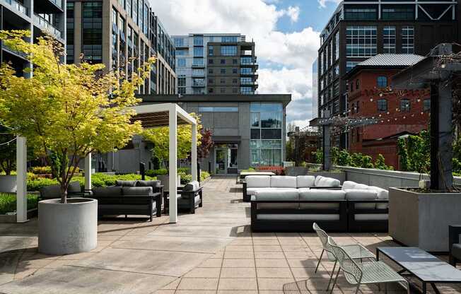 A patio with a table and chairs is surrounded by buildings.