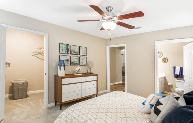a bedroom with a large bed and a ceiling fan at Crossgates Apartment Homes, Starkville, MS 39759
