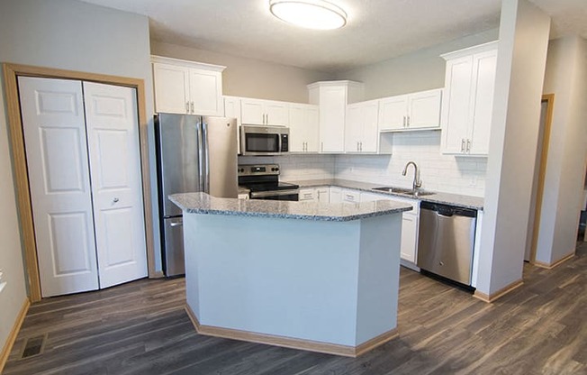 Beautifully renovated kitchen with subway tile and hardwood-like flooring at Cascade Pines Town-homes Lincoln Nebraska