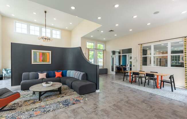 a living room with a couch and a table with chairs