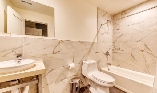 a bathroom with a sink toilet and a bath tub