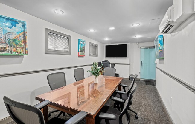 a conference room with a wooden table and chairs