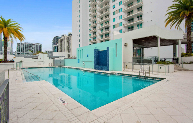 A luxurious pool beside a Miami high rise apartment building.